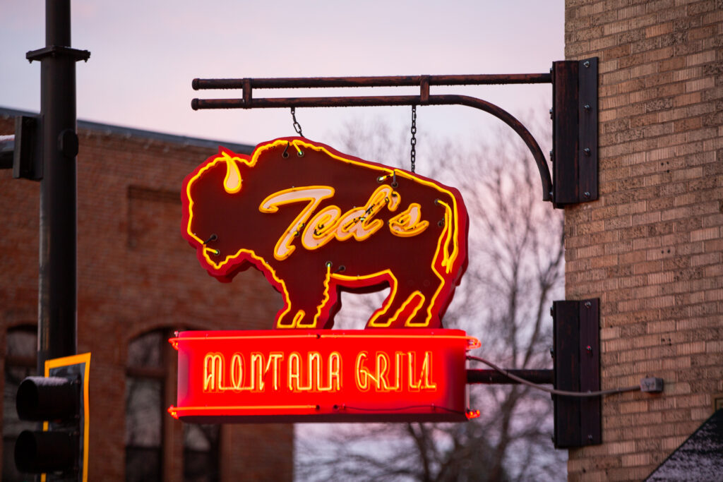 a neon street sign for Montana Grill