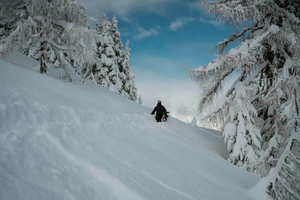 snowboarder hiking deep powder